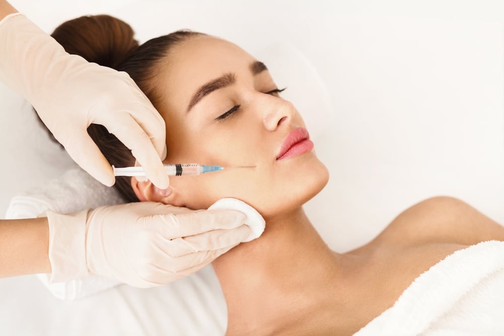 Woman with eyes closed getting midface cheek dermal filler injections in Tuscaloosa, AL